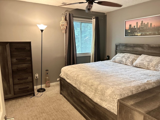 carpeted bedroom featuring a textured ceiling and ceiling fan