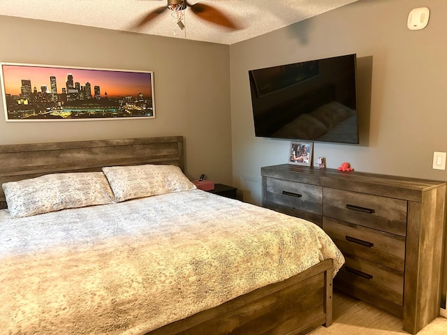 bedroom featuring a textured ceiling and ceiling fan