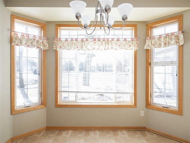 unfurnished dining area featuring a notable chandelier