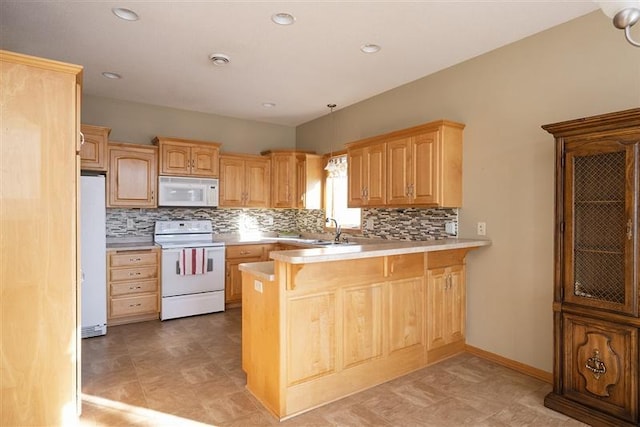 kitchen with decorative light fixtures, sink, decorative backsplash, kitchen peninsula, and white appliances