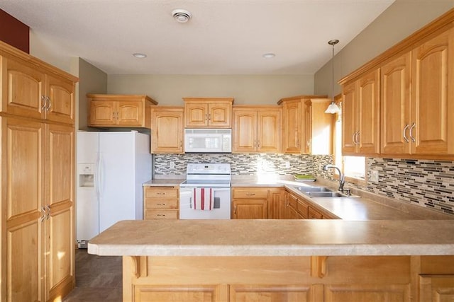 kitchen featuring tasteful backsplash, sink, white appliances, and hanging light fixtures