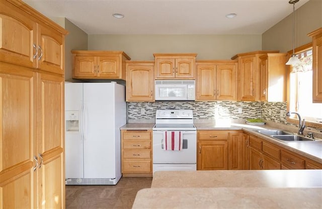 kitchen with sink, white appliances, decorative light fixtures, and decorative backsplash