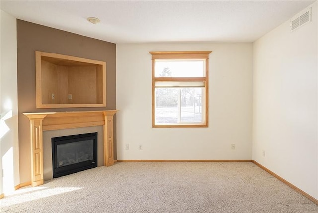 unfurnished living room with light colored carpet