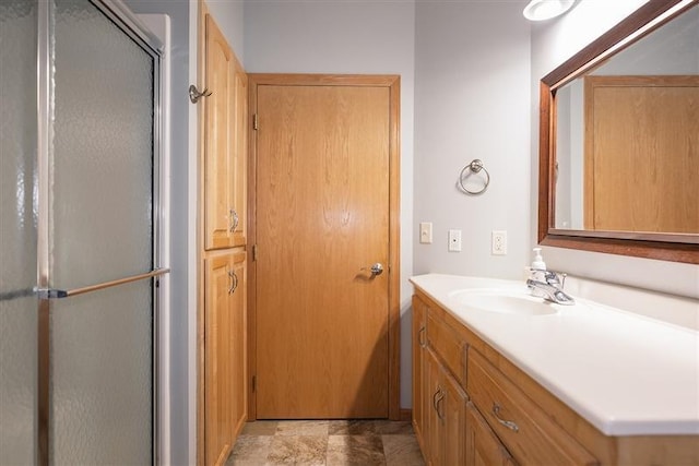 bathroom with walk in shower and vanity