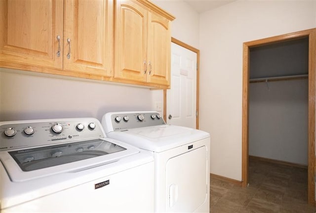 laundry area featuring cabinets and washer and clothes dryer