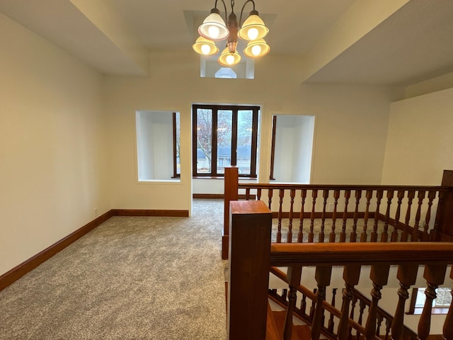 interior space with a notable chandelier and carpet flooring