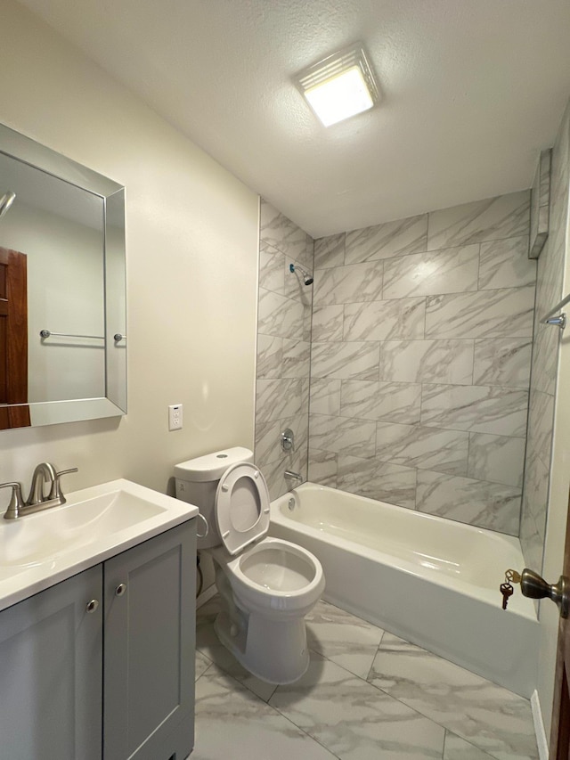 full bathroom featuring vanity, a textured ceiling, toilet, and tiled shower / bath