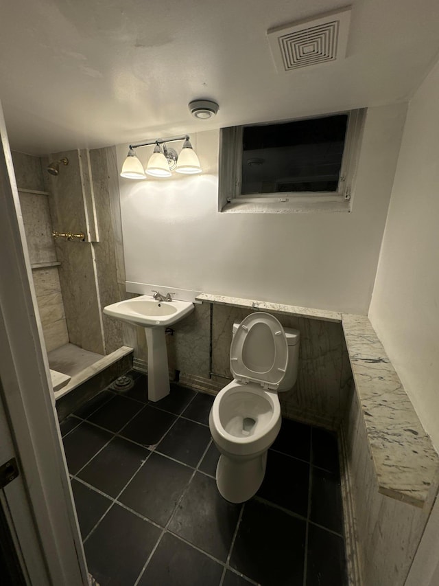 bathroom featuring walk in shower, sink, tile patterned floors, and toilet