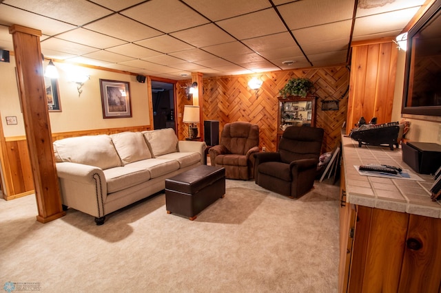 living room with light carpet and wood walls