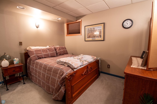 carpeted bedroom with a drop ceiling