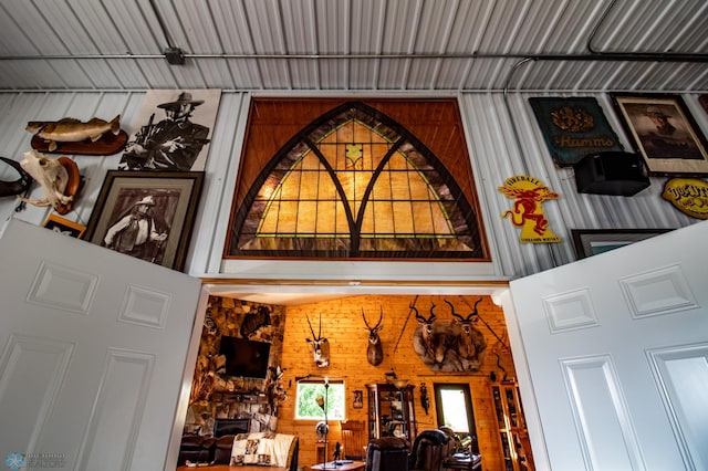 interior details featuring a fireplace and wood walls