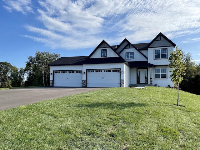 view of front of property featuring a garage and a front lawn