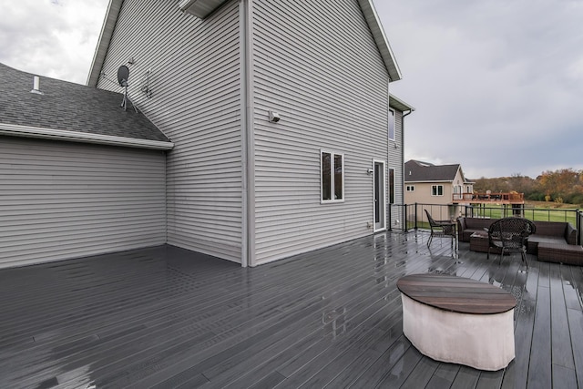 wooden terrace with an outdoor hangout area