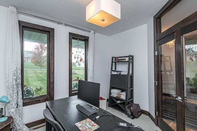 office featuring french doors, a textured ceiling, and carpet flooring