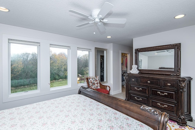 bedroom with a textured ceiling and ceiling fan