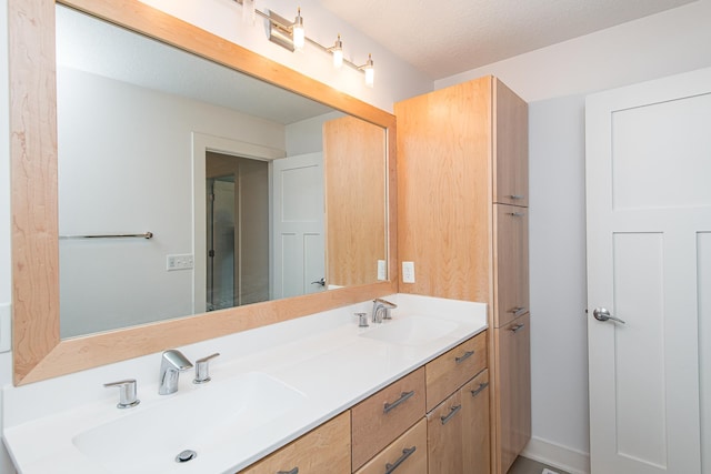 bathroom with vanity and a textured ceiling