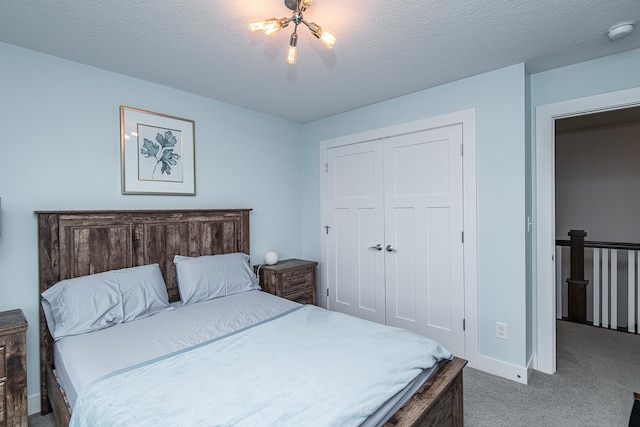 bedroom featuring a closet, a textured ceiling, and carpet flooring