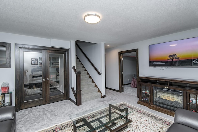 living room featuring light colored carpet and a textured ceiling