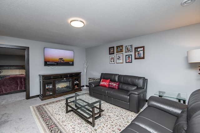 living room featuring light carpet and a textured ceiling