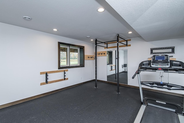 workout area featuring a textured ceiling