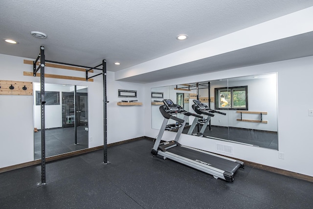 workout room with a textured ceiling