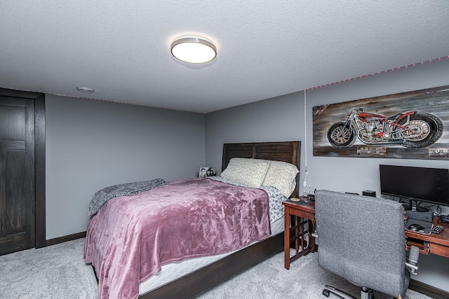 bedroom featuring light colored carpet and a textured ceiling