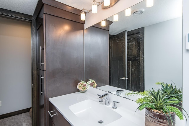 bathroom featuring vanity and a textured ceiling