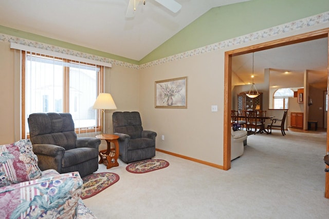 carpeted living room with lofted ceiling and ceiling fan