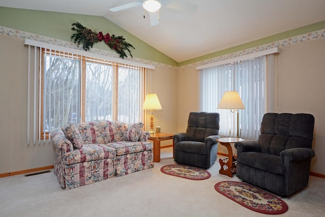 carpeted living room featuring ceiling fan, plenty of natural light, and vaulted ceiling