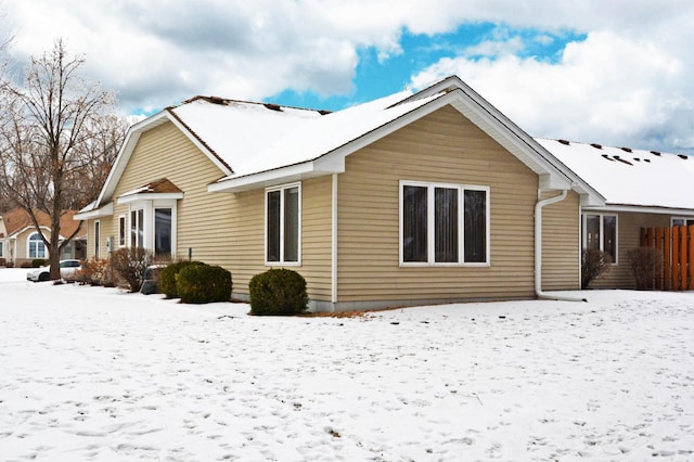 view of snow covered rear of property