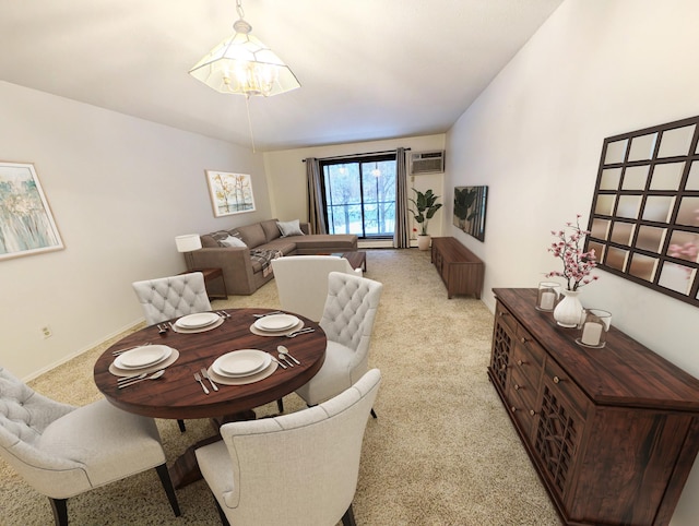 carpeted dining area featuring an inviting chandelier and a wall unit AC