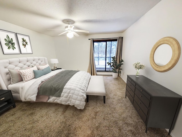 bedroom with a textured ceiling, carpet floors, and ceiling fan