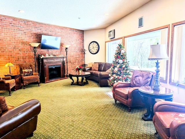 carpeted living room with visible vents and a glass covered fireplace