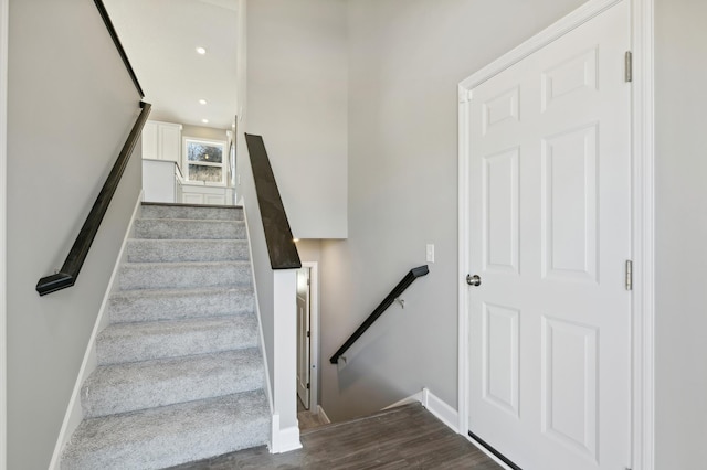 staircase with hardwood / wood-style flooring