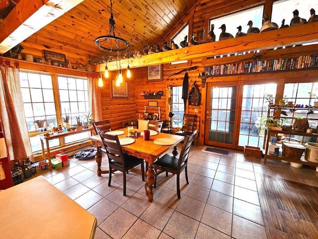 tiled dining space with wood ceiling and high vaulted ceiling