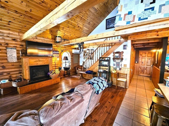 living room with beam ceiling, wood ceiling, log walls, and high vaulted ceiling