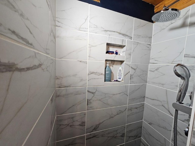 bathroom with a tile shower