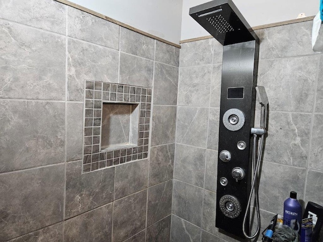 room details featuring tiled shower and a tiled fireplace