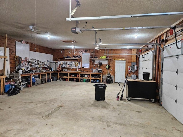 garage with a garage door opener and a workshop area