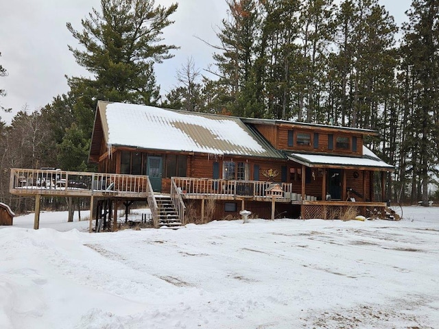 log cabin featuring covered porch