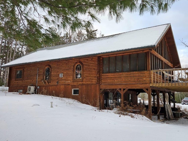 view of snow covered rear of property