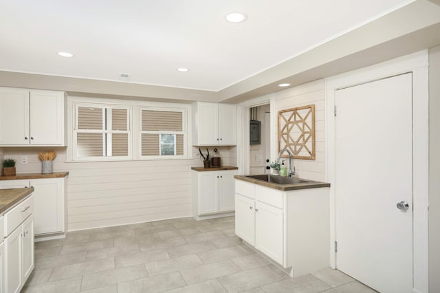 kitchen featuring white cabinetry and sink