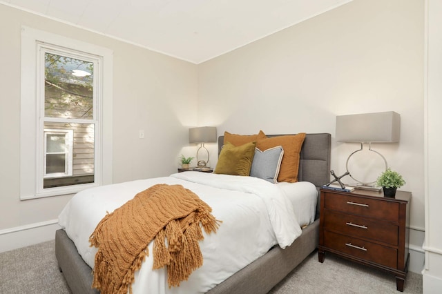 bedroom featuring light carpet