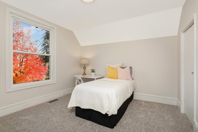 carpeted bedroom featuring vaulted ceiling