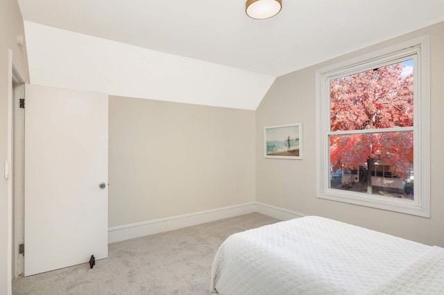 carpeted bedroom with vaulted ceiling