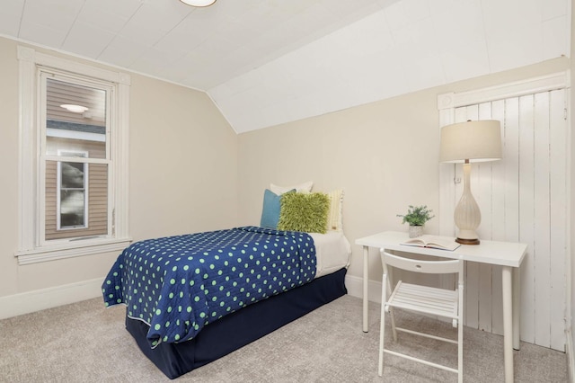 bedroom with vaulted ceiling and carpet