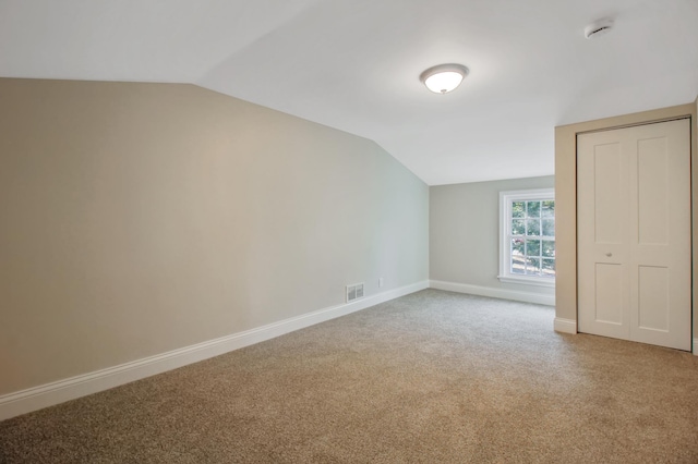 bonus room featuring carpet floors and vaulted ceiling