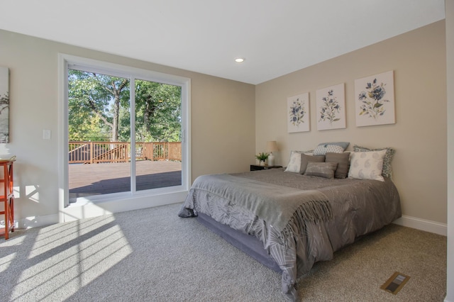 bedroom featuring light colored carpet and access to exterior