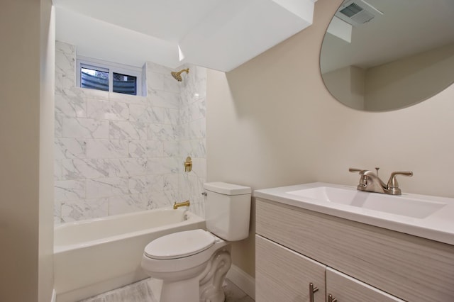 full bathroom featuring tiled shower / bath, vanity, and toilet