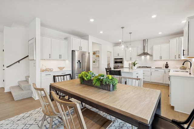 dining space with light hardwood / wood-style floors and sink